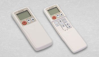 This is an image of two Mitsubishi hand held controllers, one of them has it's face opened and the other closed